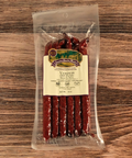 Packaged Venison Dill Pickle Snack Sticks on a wooden surface