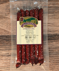 Packaged venison habanero snack sticks on a wooden surface