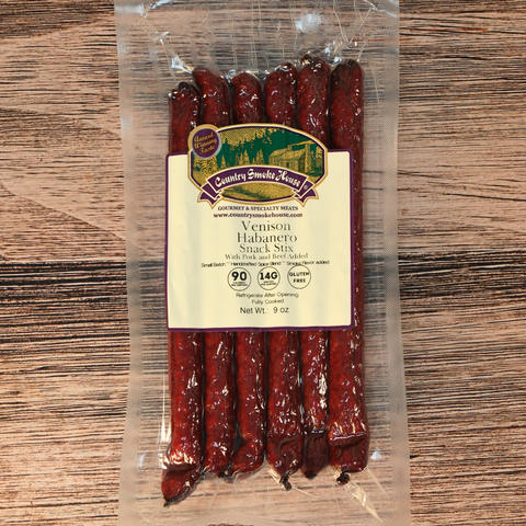 Packaged venison habanero snack sticks on a wooden surface