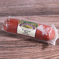 Packaged Venison Hot Salami chub on a wooden surface.