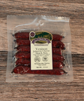 Packaged Venison Jalapeno Cheese Snack Sticks on a wooden surface