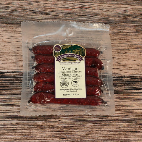 Packaged Venison Jalapeno Cheese Snack Sticks on a wooden surface
