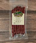 Packaged Venison jalapeno cheese snack Sticks on a wooden surface