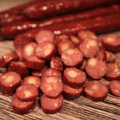 Close-up of Venison jalapeno cheese snack Stick slices  on a wooden surface