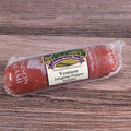 A packaged Venison Jalapeno Pepper Salami Chub on a wooden surface.