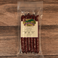 Packaged Venison Jalapeno Pepper Snack Stix on a wooden surface