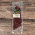 Packaged venison jerky on a wooden surface