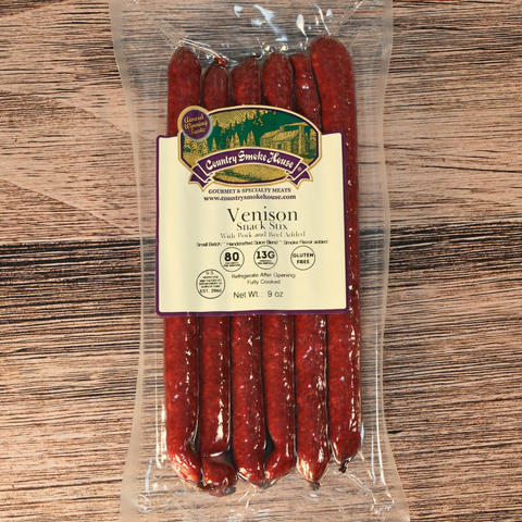 Packaged venison mild snack stick with a label on a wooden surface