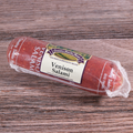 A packaged Venison Salami Chub on a wooden surface.
