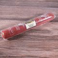 A packaged of Venison Long Salami on a wooden surface.