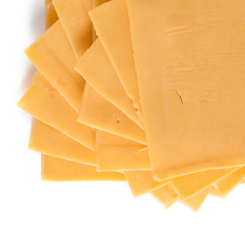 A stack of thick, golden-yellow cheese slices fanned out on a clean white background.