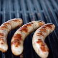 Savory German Brats cooking on the grill